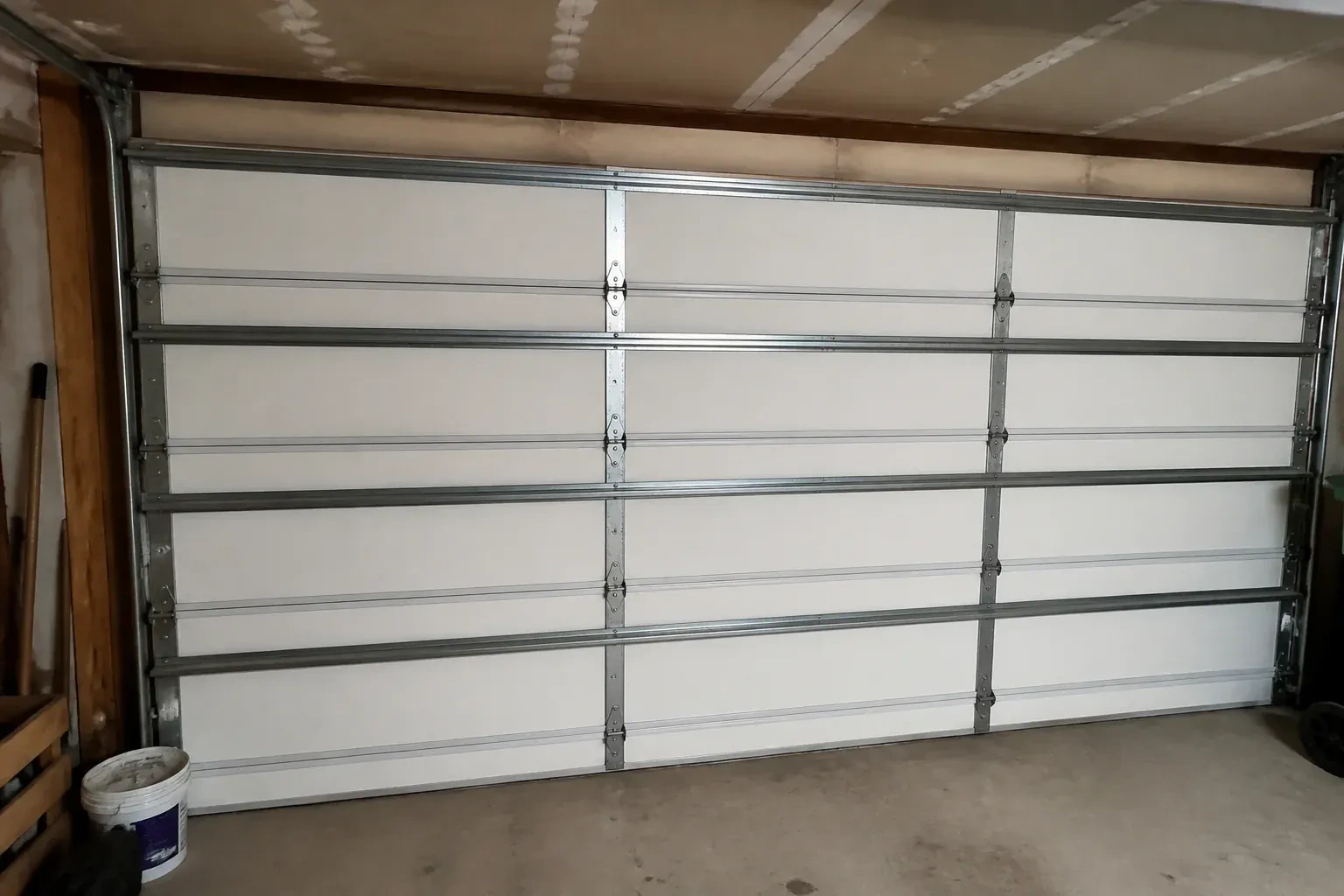 Interior of a closed sectional door with horizontal metal reinforcement struts. — Wind-Rated Garage Door Replacement, Whitchurch-Stouffville